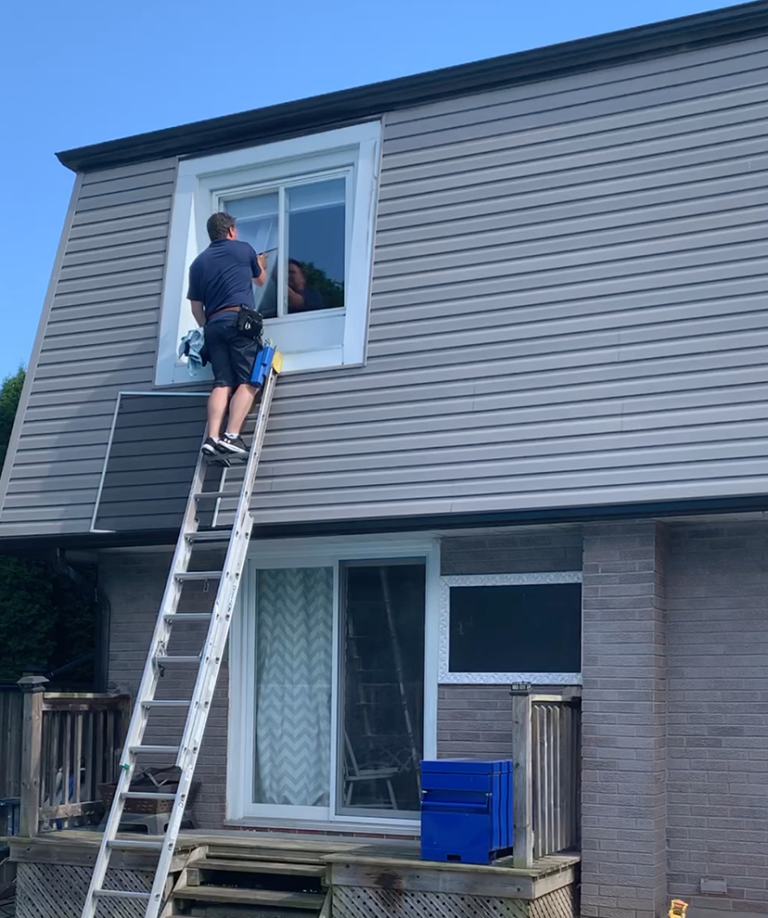 Window cleaning on ladder