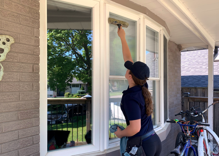 Crew member cleaning window